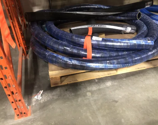 Orange strap bundling blue hose