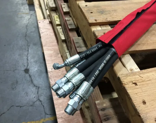 Red sleeve bundling hydraulic hoses