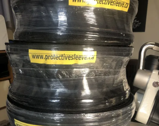 Coiled hose in labelled sleeve