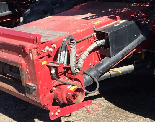 Sleeved hoses on a harvester header