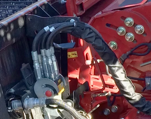 Black sleeve on farm equipment hoses
