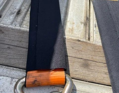 Strap saver on a ratchet strap