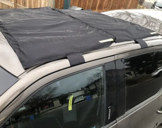 Straps holding a hail cover