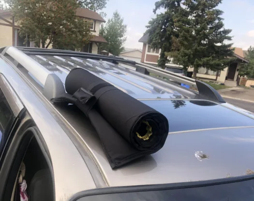 Hail cover rolled up on a roof rack