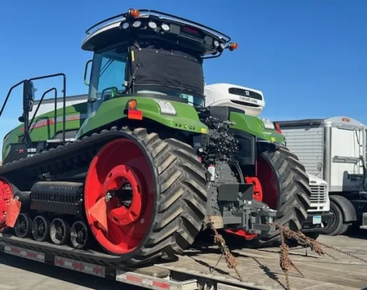 Covered tractor on a lowboy trailer