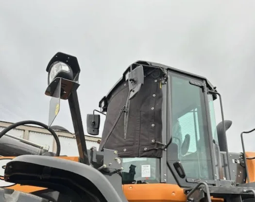 Windshield cover on a loader cab