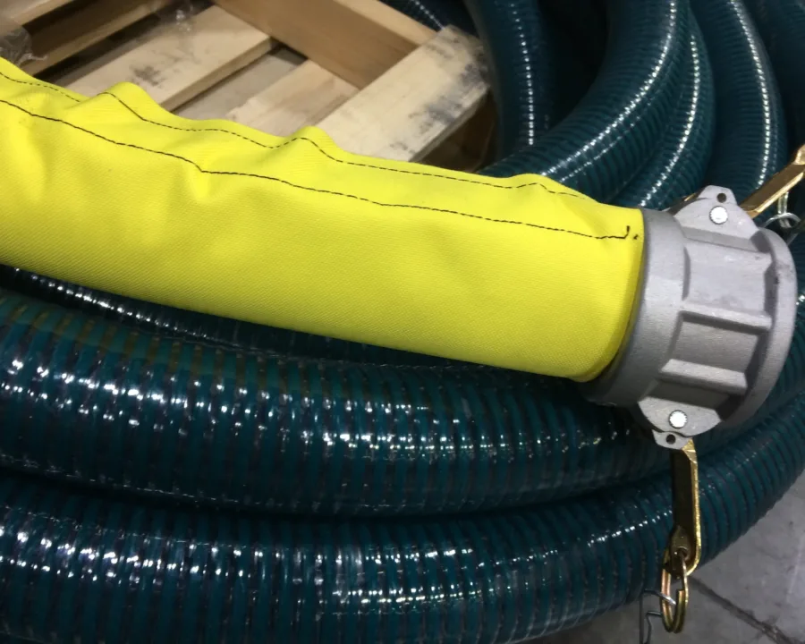 Yellow sleeve over a suction hose