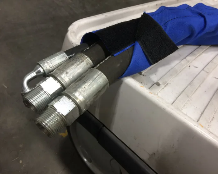 Blue sleeve on hydraulic hoses