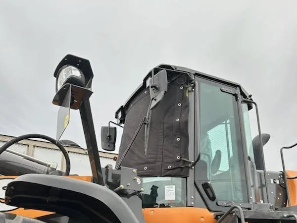 Windshield cover on a loader cab